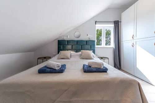 a bedroom with a large bed with two pillows on it at Divine Apartment in Mlini