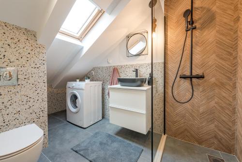 a bathroom with a toilet sink and a washing machine at Divine Apartment in Mlini