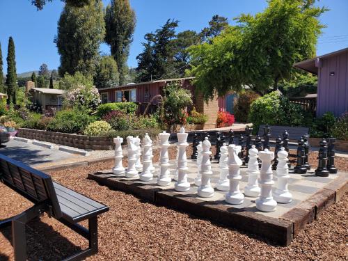 a giant chessboard in a garden with a bench at Carmel Valley Lodge in Carmel Valley