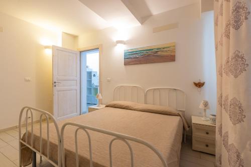a bedroom with a bed and a window at Leuca Mon Amour in Leuca