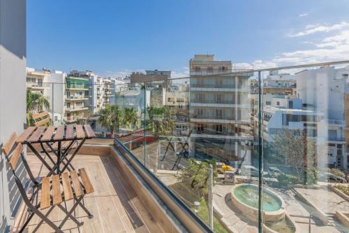 a balcony with chairs and a view of a city at Raise Kornarou City Stay in Heraklio Town