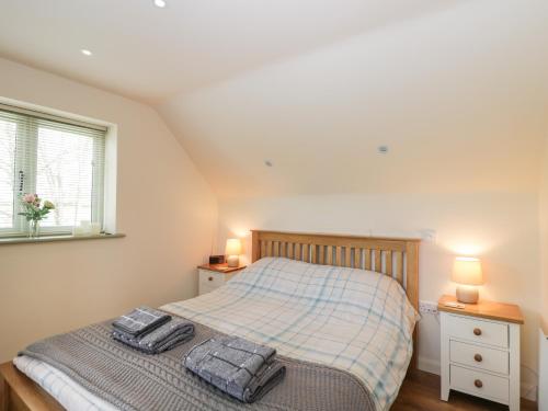 a bedroom with a bed with two towels on it at Shephards Retreat in Kingsdon