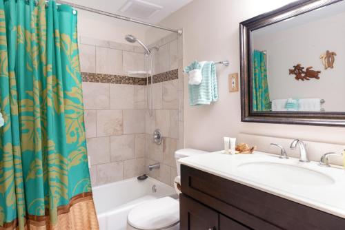 Un baño con lavabo, ducha e inodoro. en Alii Villas 201, en Kailua-Kona
