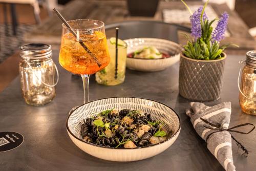 a table with three bowls of food and a drink at The ART INN Lisbon in Lisbon
