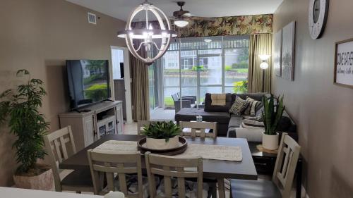 a dining room and living room with a table and chairs at Vacation in Paradise in Lely Resort