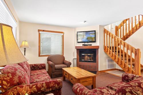 a living room with a couch and a fireplace at Club Wyndham Shawnee Village in East Stroudsburg