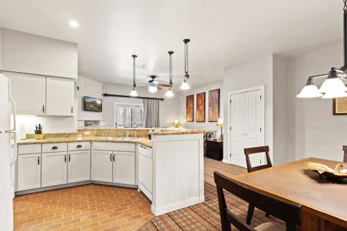 a kitchen and dining room with white cabinets and a table at Club Wyndham Shawnee Village in East Stroudsburg