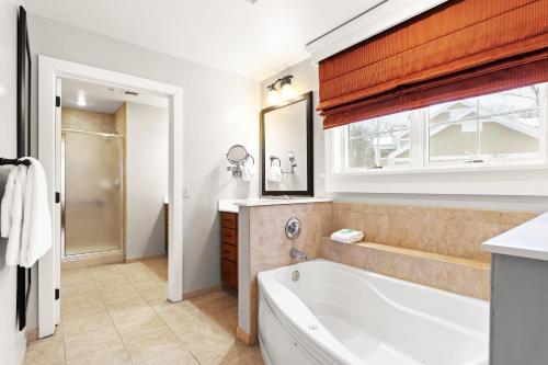 a bathroom with a tub and a window at Club Wyndham Shawnee Village in East Stroudsburg