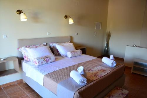 a bedroom with a bed with towels on it at Elianthos Villas in Vamos