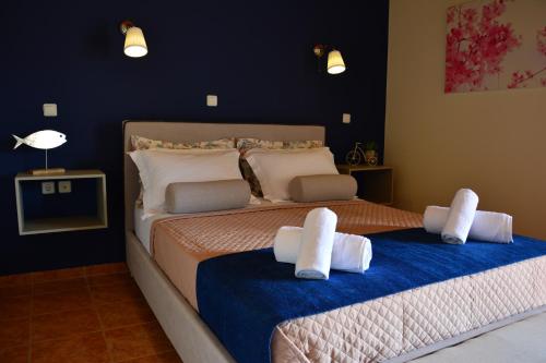 a bedroom with two beds with towels on them at Elianthos Villas in Vamos