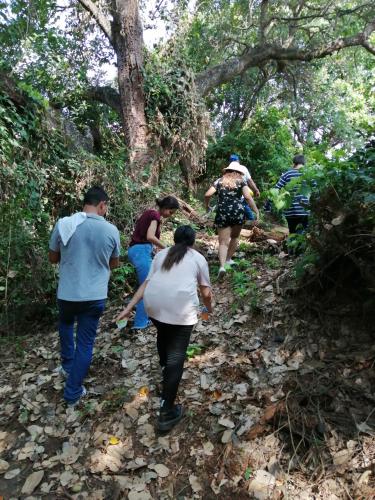 a group of people walking down a trail at Finca Ecoturistica LOS JAGUEYES in Baraya