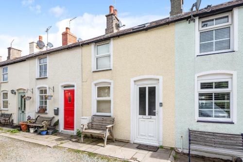 a row of houses with a red door at Fishermans Cottage in Conwy