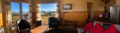 a living room with a view of a mountain at Ventisca Sur in Coihaique
