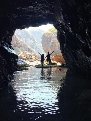 two people standing in front of a cave at With DiO in Setouchi