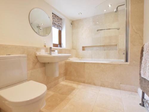 a bathroom with a toilet and a sink and a shower at Brynawelon in Newport