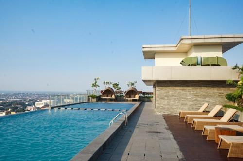 a swimming pool on the roof of a building at Louis Kienne Hotel Pemuda in Semarang