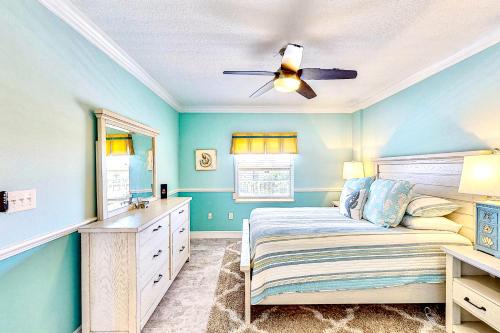 a bedroom with a bed and a ceiling fan at Shorewood in Cape Canaveral