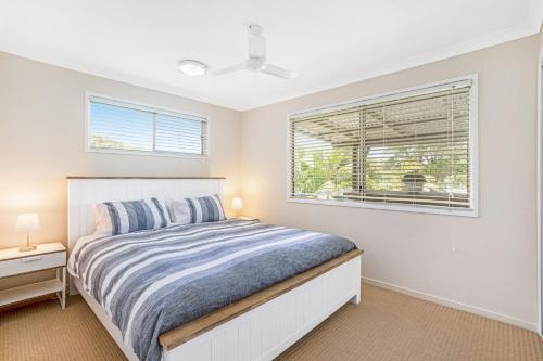 a bedroom with a bed and a window at 17 Green Valley Drive Rainbow Beach in Rainbow Beach