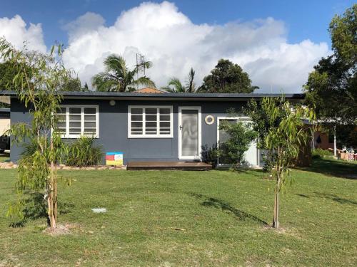a house with two trees in front of it at 9 Indigo Avenue Rainbow Beach in Rainbow Beach