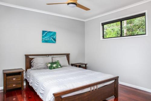 a bedroom with a bed and a ceiling fan at 11 Naiad Court Rainbow Shores in Rainbow Beach