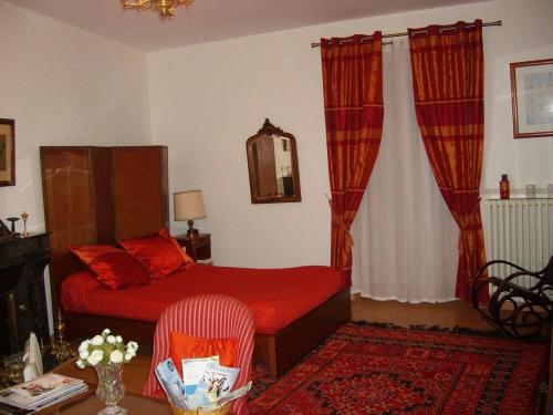 a bedroom with a bed and a table with a chair at Lalobema in Machecoul