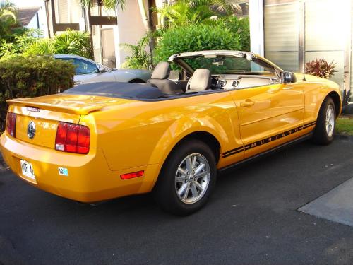 a yellow convertible car parked in a parking lot at OUTSTANDING OCEANFRONT STUDIO - KONA ISLANDER INN CONDOS condo in Kailua-Kona