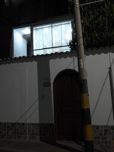 a door to a building with a window and a pole at Casablanca 2 in Tacna