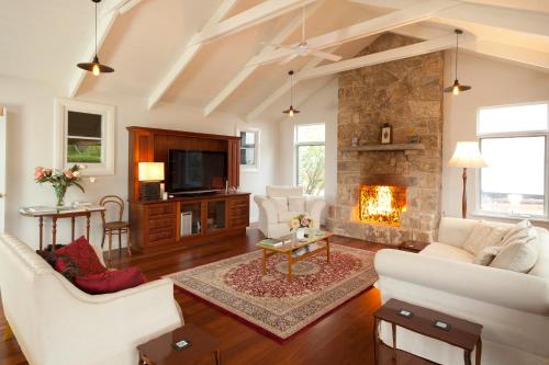 a living room with a couch and a fireplace at The Grange on Kalgan Farmstay, Albany WA in Albany