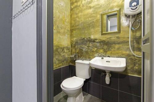 a bathroom with a toilet and a sink at Lucky Hotel in Sungai Petani
