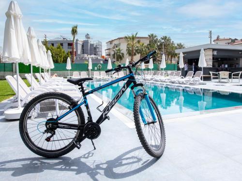a bike parked next to a swimming pool at A Suite Side in Side