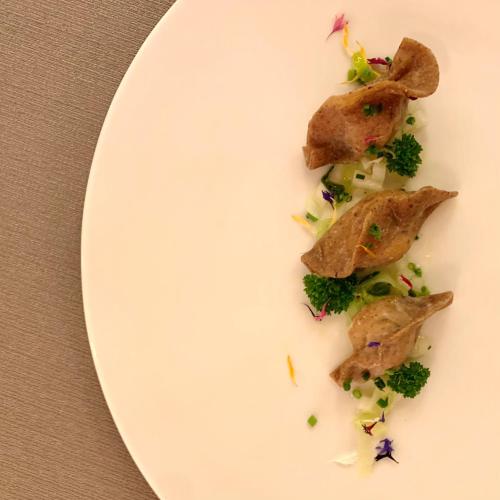a white plate with some food on it at Hotel Waldhof in Perca