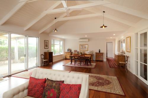 a living room with a couch and a table at The Grange on Kalgan Farmstay, Albany WA in Albany