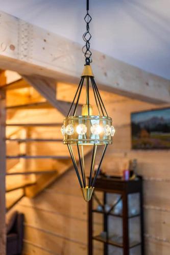 a chandelier hanging from a ceiling in a room at Przedsionek Tatr in Zakopane