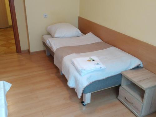 a pair of beds in a room with a table at CKS Kraków (Centrum Konferencyjno-Szkoleniowe CS Natura Tour) in Kraków