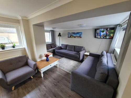 a living room with two couches and a table at Holyrood House in Edinburgh