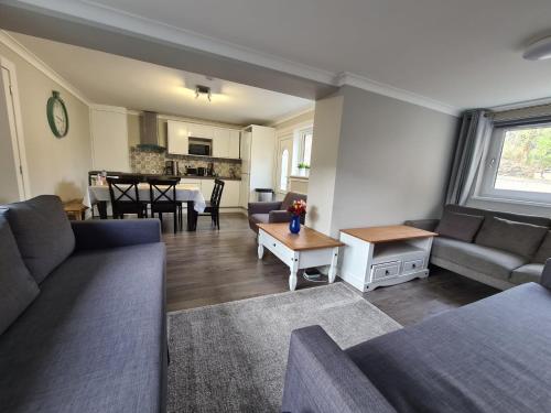 a living room with a couch and a table at Holyrood House in Edinburgh