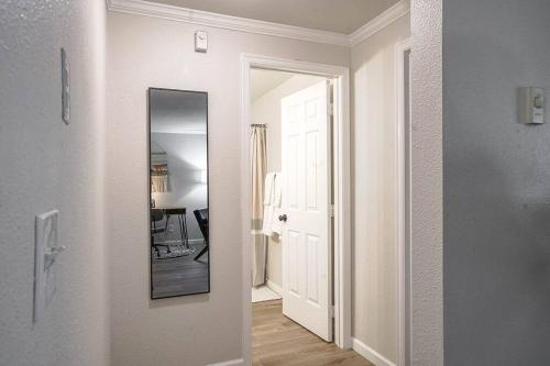 a hallway with a mirror and a white door at Condo with king bed, walk to Microsoft & park in Bellevue