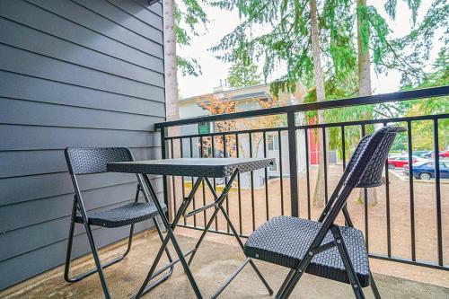 a table and two chairs sitting on a balcony at Condo with king bed, walk to Microsoft & park in Bellevue