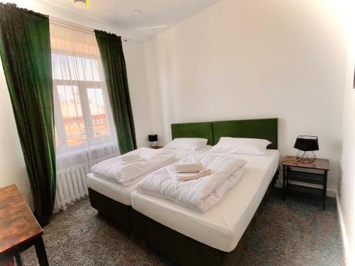 a large bed in a room with a large window at Green apartments Easy Kaunas in Kaunas
