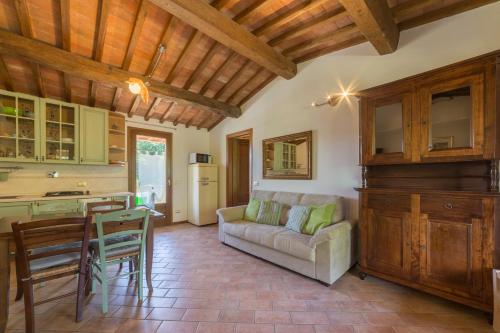a kitchen and living room with a couch and a table at Borgo da Vinci in Volterra