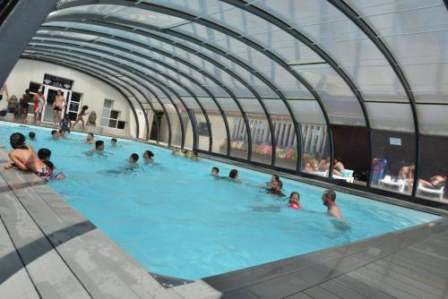 un groupe de personnes nageant dans une piscine dans l'établissement Camping Airotel le Sen-Yan, à Mézos