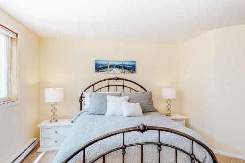 a bedroom with a large bed and two lamps at South Village #49 in Warren