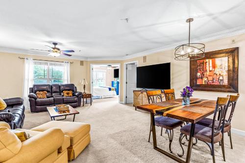 a living room with a table and a tv at Crow Creek Perch in Calabash