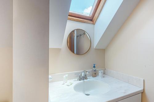 a bathroom with a sink and a mirror at South Village #49 in Warren
