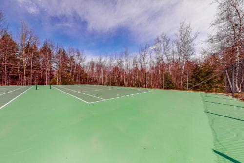 an empty tennis court with trees in the background at South Village #49 in Warren