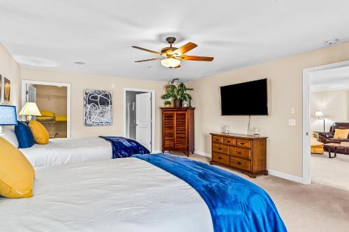 a bedroom with two beds and a flat screen tv at Crow Creek Perch in Calabash