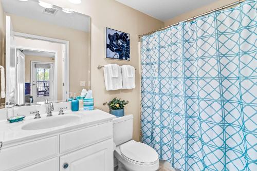 a bathroom with a shower with a toilet and a sink at Crow Creek Perch in Calabash