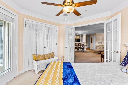 a bedroom with a bed and a ceiling fan at Crow Creek Perch in Calabash