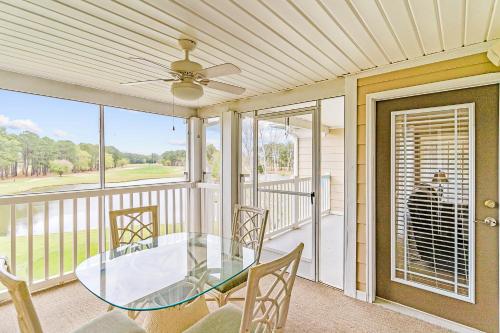 a screened porch with a glass table and chairs at Crow Creek Perch in Calabash