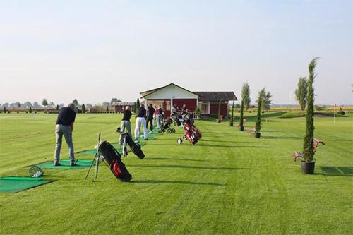 a group of people playing golf in a field at Maisonette am Belchen in Bad Krozingen